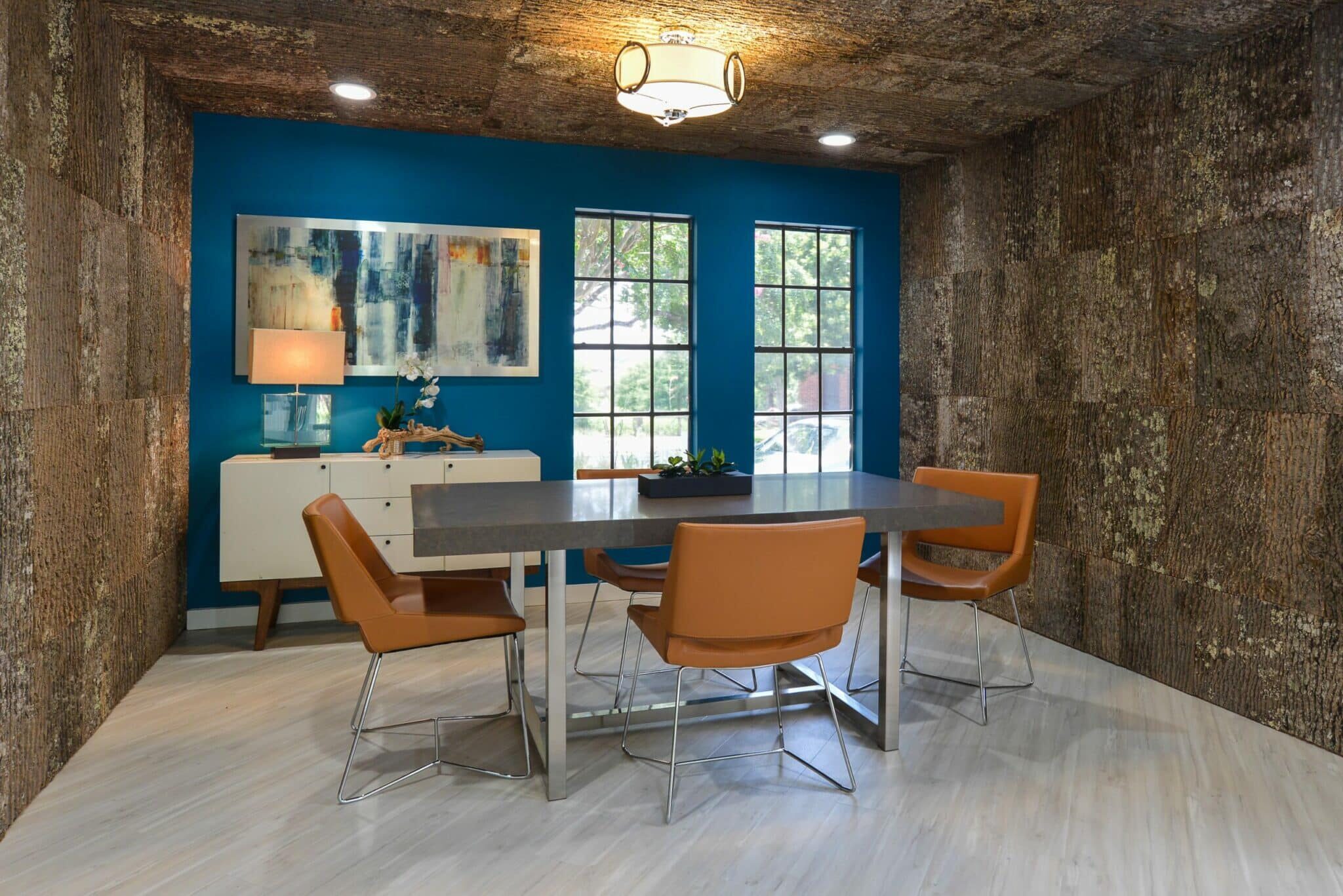 Wood ceiling panels and decorative textured wall coverings in a mod dining room