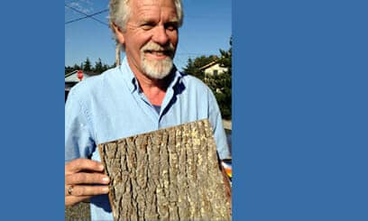 Bob at G Little Construction holds up a Bark House Brand Bark Shake