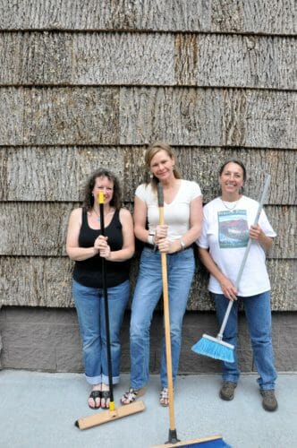 Clean up crew at the poplar bark sided Main Street Central Park Building