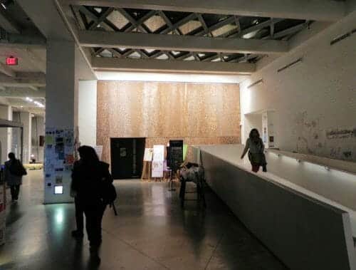 Hallway featuring poplar bark textured wall paneling