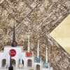 Bark House gold birch wall covering panels at an angle behind Louboutin nail polishes