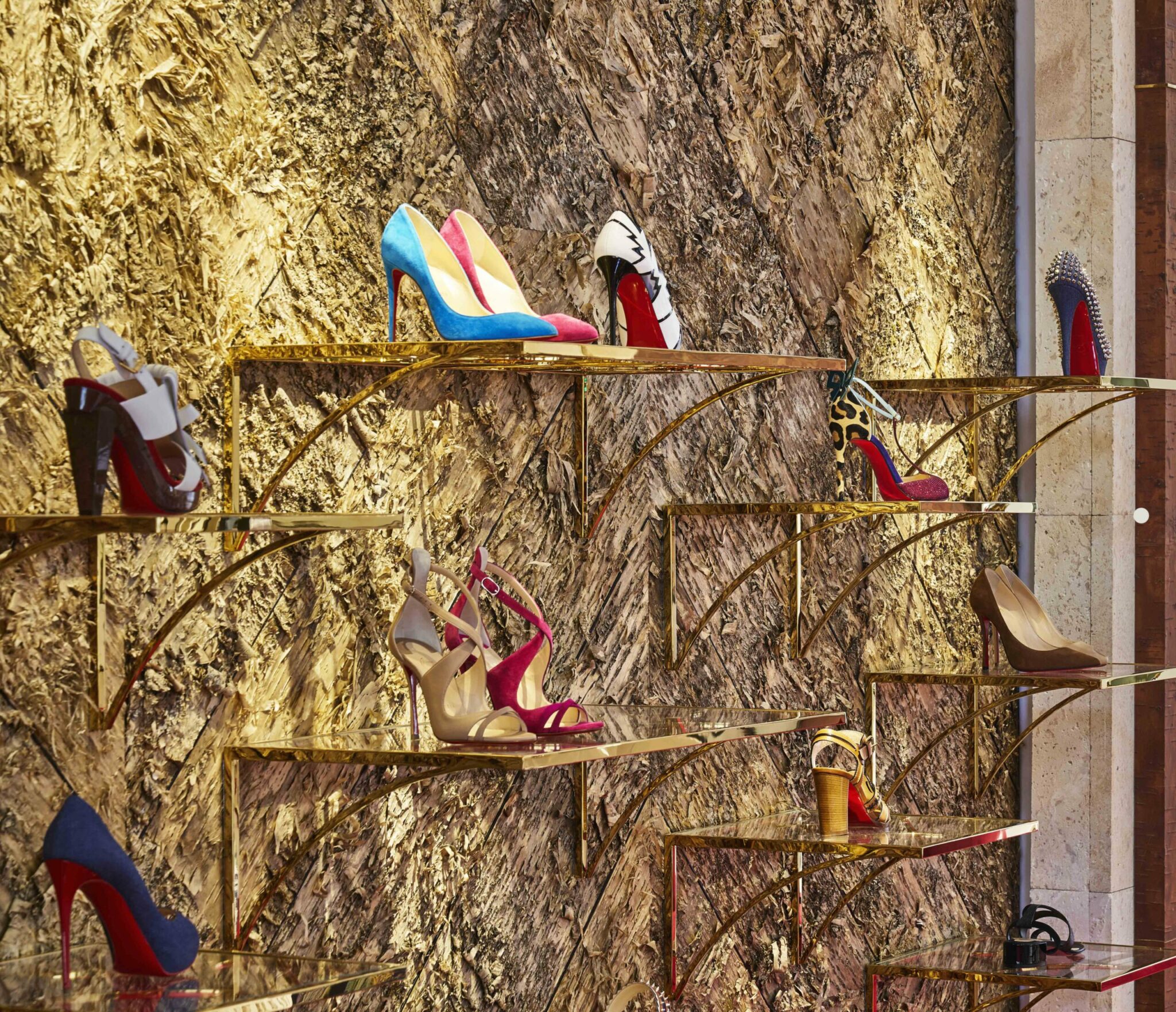 Bark House gold birch wall covering panels at an angle behind Christian Louboutin shoes in Miami boutique