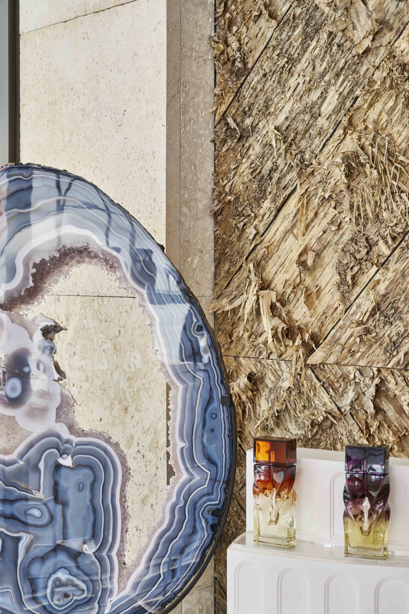 A geode sets off Bark House Gold (yellow) birch bark wall treatment in Christian Louboutin Shoe Boutique in Miami FL.