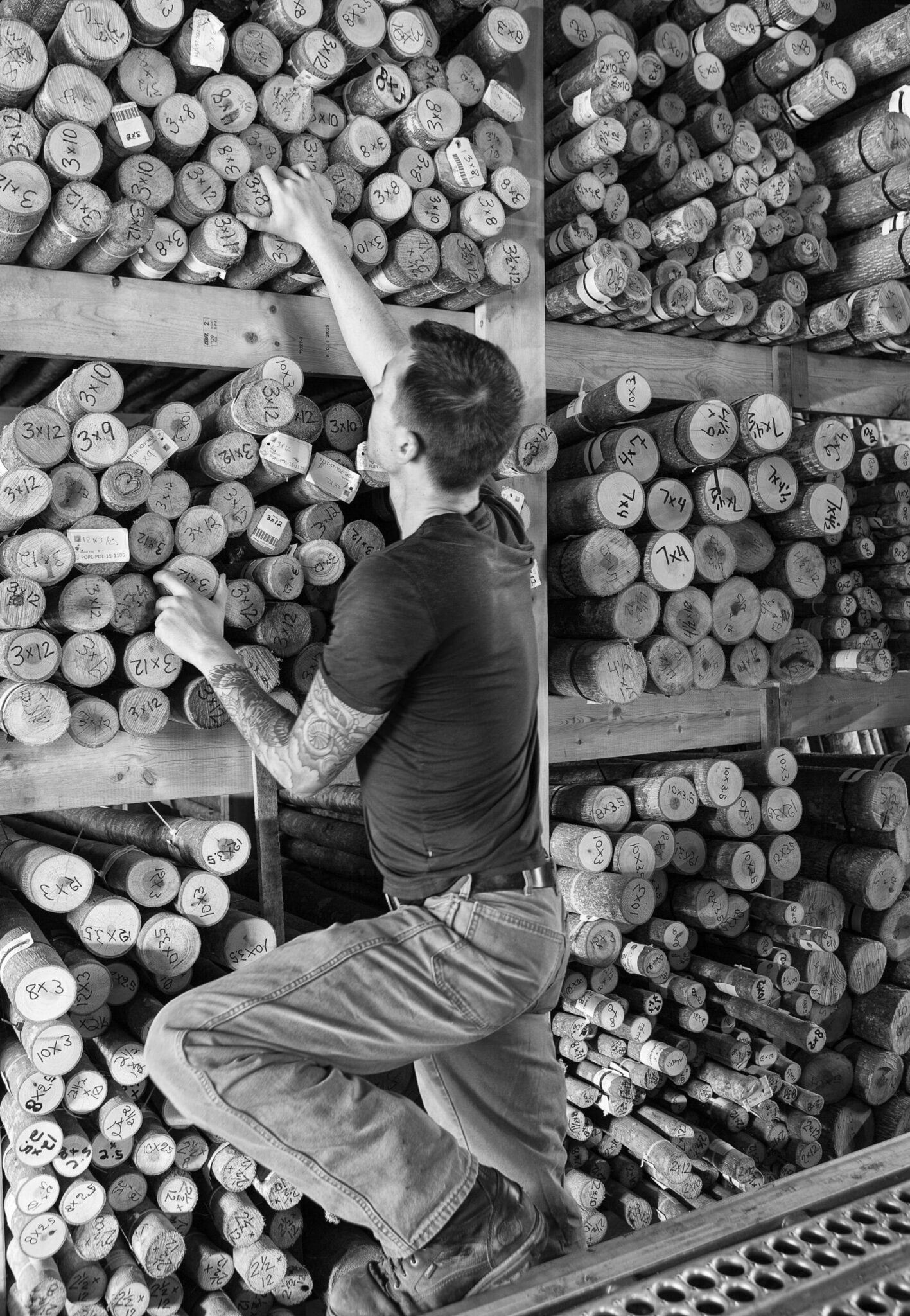 Bark House searching through poplar poles to make end cuts for wall covering panels