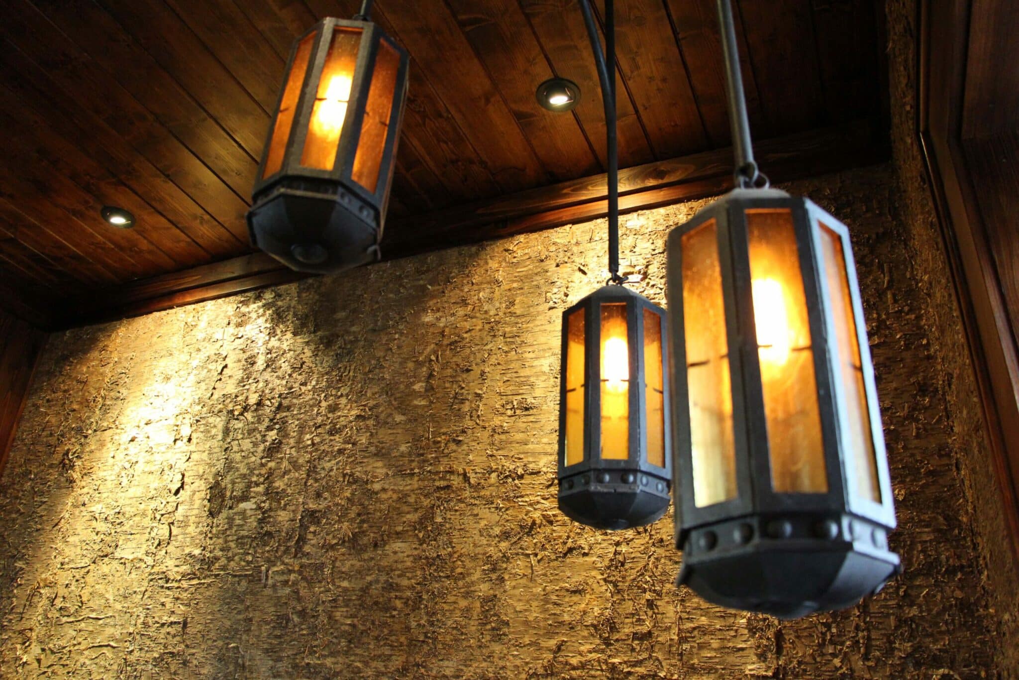 bark-house-gold-birch-bark-wall-covering-panels-iron-light-fixtures